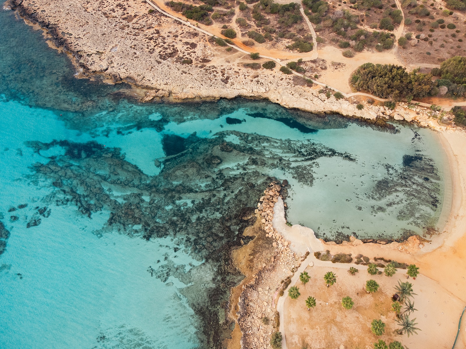 Photo by Kamil Molendys an aerial view of a beach with blue water